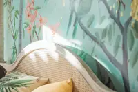 Close-up of a tropical wall mural above a bed in the Coco Casita at Boardwalk Boutique Hotel Aruba.