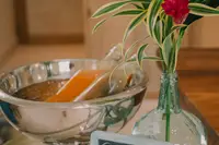 Morning shot of a welcome amenity at Boardwalk Boutique Hotel Aruba with an ice bucket, bottle, and tropical flower arrangement on a tray.