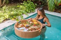 Guest enjoying a floating breakfast tray in a private plunge pool at Boardwalk Boutique Hotel Aruba.