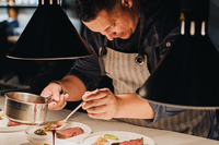 Ever chefs table restaurant Fine dining chef plating an adults-only dinner in Aruba at restaurants like The Coco Café, curated by Boardwalk Boutique Hotel Aruba.