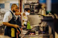 Chef preparing an adults-only fine dining experience in Aruba at venues such as The Coco Café, recommended by Boardwalk Boutique Hotel Aruba.