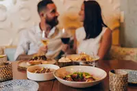Couple enjoying an adults-only dinner in Aruba at Lima Bistro and The Coco Café, recommended by Boardwalk Boutique Hotel Aruba.