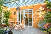 Coco Deluxe Casita private terrace with outdoor dining and tropical garden setting at Boardwalk Boutique Hotel Aruba.