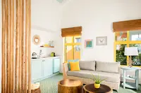 Open-plan Coco Casita interior with lounge seating and kitchenette at Boardwalk Boutique Hotel Aruba.