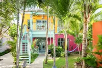 Coco Casita exterior at Boardwalk Boutique Hotel Aruba surrounded by lush tropical gardens and colorful decor.
