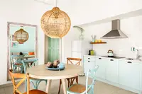 One-Bedroom Casita dining area and kitchen at Boardwalk Boutique Hotel Aruba with island-style decor.