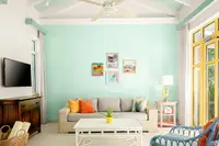 One-Bedroom Casita lounge at Boardwalk Boutique Hotel Aruba with sofa seating and bright island accents.