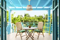 One-Bedroom Casita terrace at Boardwalk Boutique Hotel Aruba with outdoor dining and tropical views.