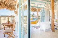 Palapa Lodge at Boardwalk Boutique Hotel Aruba with open-air terrace seating and bright tropical interior