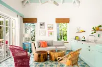 Plunge pool casita living area at Boardwalk Boutique Hotel Aruba with patterned tile floor, sofa seating, and kitchenette.