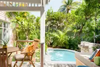 Casita terrace with seating overlooking a private plunge pool in a tropical garden at Boardwalk Boutique Hotel Aruba.