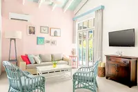 Two-Bedroom Casita living room at Boardwalk Boutique Hotel Aruba with bright seating area and TV.