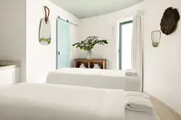 Spa treatment room at Boardwalk Boutique Hotel Aruba with massage tables and a calm, minimalist interior.