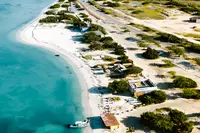 Aerial drone view of Aruba’s coastline with turquoise water and white-sand beach