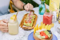 Breakfast at the Coco Café at Boardwalk Boutique Hotel Aruba with fresh fruit, toast, and drinks.