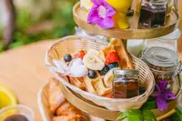 Breakfast stand with pastries and fresh fruit at The Coco Café at Boardwalk Boutique Hotel Aruba.