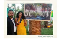 Guests posing with a framed photo during Boardwalk Boutique Hotel Aruba Bloggers Weekend 2014 in the tropical gardens.