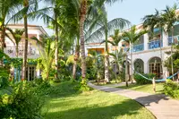 Lush tropical gardens at Boardwalk Boutique Hotel Aruba, reflecting the resort’s eco-friendly design and Green Globe Certification commitment.