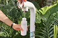Reusable water bottle being refilled at Boardwalk Boutique Hotel Aruba as part of its Green Globe Certification sustainability efforts.