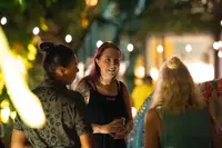Guests enjoying a Movie Under the Stars at Boardwalk Boutique Hotel Aruba, featuring a video by Nathalie Clemens about Aruba’s wildlife.