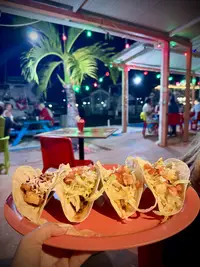 Taco Tuesday platter at Lucy’s in Aruba, featuring assorted tacos served outdoors.