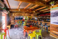 Interior of a colorful local store in Pos Chiquito, Aruba, with Caribbean decor and souvenirs.