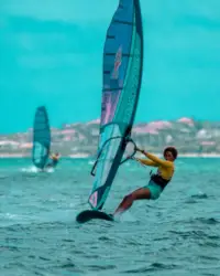 Windsurfing on Palm Beach in Aruba near Boardwalk Boutique Hotel Aruba, showcasing the island’s vibrant sports scene.