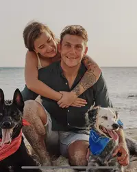 Family and rescue dogs on Palm Beach in Aruba near Boardwalk Boutique Hotel Aruba, reflecting compassion and island life.