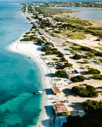 Aerial drone view of Aruba’s coastline with turquoise water and white-sand beach