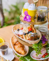 Breakfast stand with pastries and fresh fruit at The Coco Café at Boardwalk Boutique Hotel Aruba.