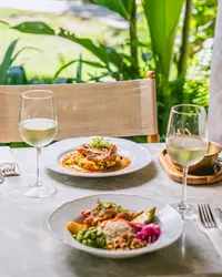 Lunch at The Coco Café at Boardwalk Boutique Hotel Aruba served at an outdoor garden table.