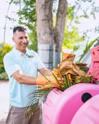 Team member of Boardwalk Boutique Hotel Aruba participating in a sustainability initiative as part of the Green Globe Certification commitment.