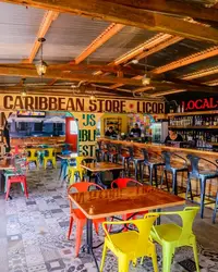 Interior of a colorful local store in Pos Chiquito, Aruba, with Caribbean decor and souvenirs.